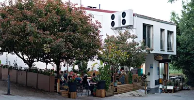 a group of people sitting outside of a building at Cruce de Caminos Arzúa in Arzúa