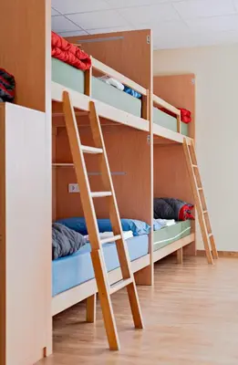 a room with bunk beds in a hostel at Cruce de Caminos Arzúa in Arzúa
