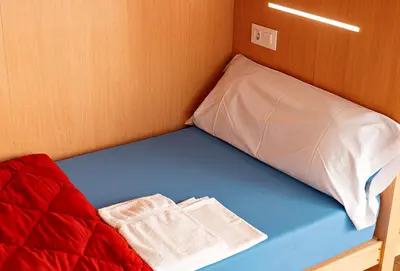 a bed with two towels sitting on top of it at Cruce de Caminos Arzúa in Arzúa