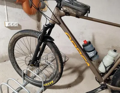 a bike parked in a garage next to a wall at Cruce de Caminos Arzúa in Arzúa