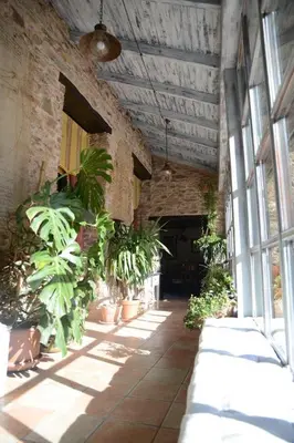a hallway with plants in a brick building at Casa Rural Pico del Lugar in Villar de los Barrios