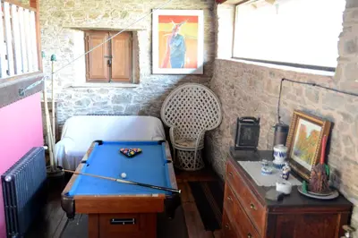 a room with a pool table and a bed at Casa Rural Pico del Lugar in Villar de los Barrios