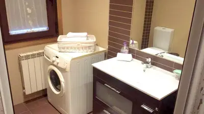 a bathroom with a washing machine and a sink at Elegant House in Pontevedra + Private Pool in Rífrío