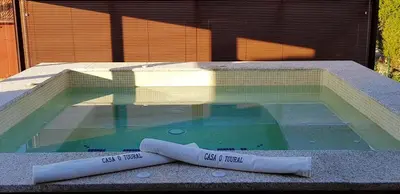 a swimming pool with two towels in the water at Elegant House in Pontevedra + Private Pool in Rífrío
