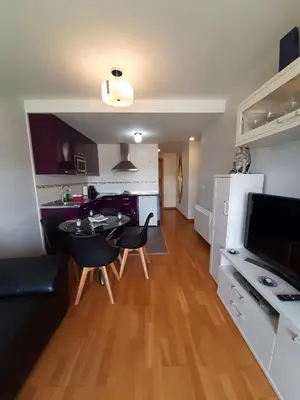 a kitchen and living room with a table and chairs at Lugomar in Foz