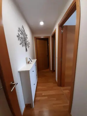 a hallway with a dresser and a hallway with a door at Lugomar in Foz