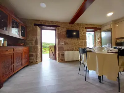 a kitchen with a table and chairs in a room at Casa Xan in Jove