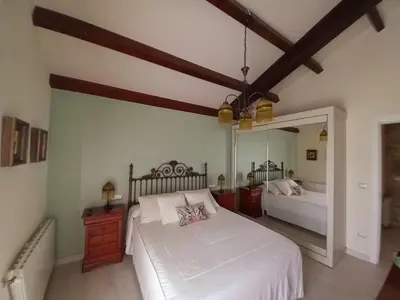 a bedroom with a bed and a large mirror at Casa Xan in Jove