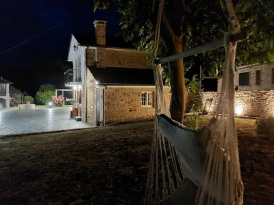 a hammock hanging from a tree in front of a building at Casa Xan in Jove