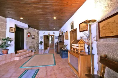 a room with a hallway with a rug on the floor at Casal de Drados in Drados