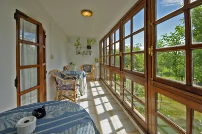 a room with large windows and a table and chairs at Casal de Drados in Drados