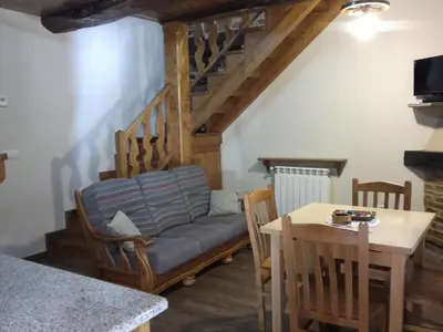 a living room with a couch and a table at Apartamento El Valle de Oscos in Santa Eulalia de Oscos