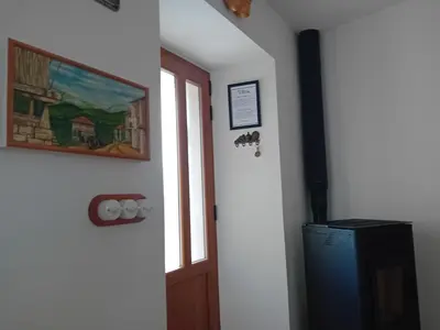 a room with a door and a picture and a television at Stone Cottage O CEBREIRO in Curtis