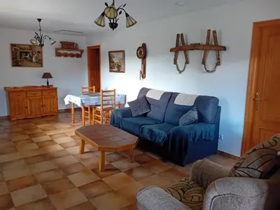 a living room with a blue couch and a table at Stone Cottage O CEBREIRO in Curtis