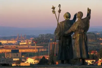 a statue of two women standing on top of a hill at Stone Cottage O CEBREIRO in Curtis