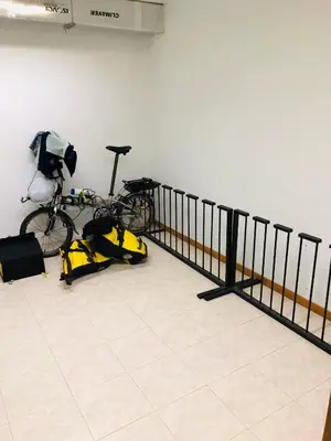 a bike parked in a room with a fence at Albergue la Estacion Santiago de Compostela in Santiago de Compostela