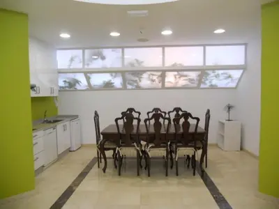 a kitchen with a table with four chairs in it at Albergue la Estacion Santiago de Compostela in Santiago de Compostela