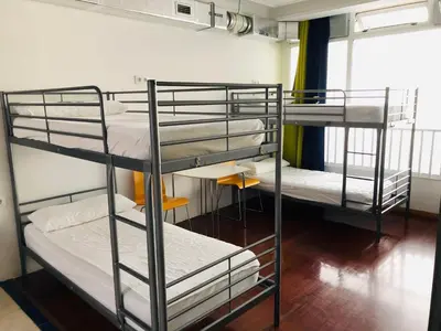 a room with three bunk beds in a room at Albergue la Estacion Santiago de Compostela in Santiago de Compostela