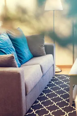 a couch with blue pillows in a living room at Duerming Sea View Viveiro in Viveiro