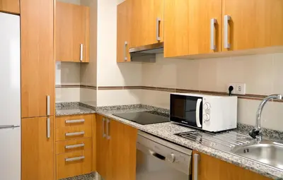 a small kitchen with a sink and a microwave at Duerming Sea View Viveiro in Viveiro