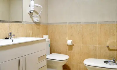 a bathroom with a toilet and a sink and a mirror at Duerming Sea View Viveiro in Viveiro