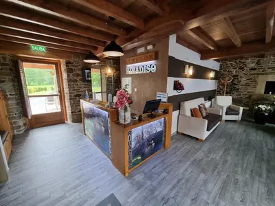 a lobby with a reception desk in a building at Pensión Ribadiso in Arzúa
