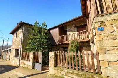 a house with a wooden fence in front of it at Casas Rurales Trefacio in Trefacio