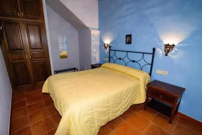 a bedroom with a bed in a blue room at Casas Rurales Trefacio in Trefacio