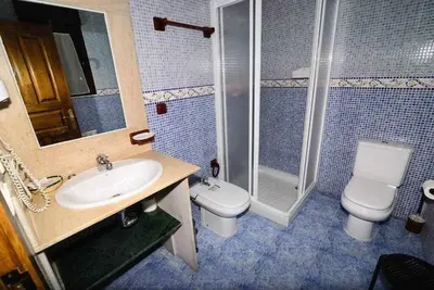 a bathroom with a sink and a toilet and a shower at Casas Rurales Trefacio in Trefacio