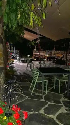 a patio with a table and chairs and flowers at Casa Rural Chao de Castro in Ríodeporcos
