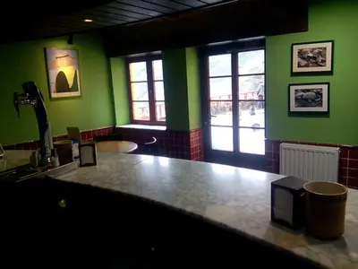 a kitchen with green walls and a large counter top at Hotel Las Grandas in Vistalegre