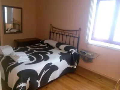 a bedroom with a bed with a black and white comforter at Hotel Las Grandas in Vistalegre