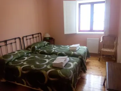 two beds sitting in a room with a window at Hotel Las Grandas in Vistalegre