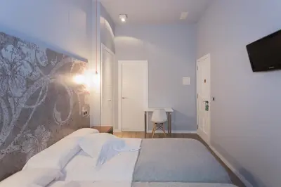 a bedroom with a bed and a tv on a wall at Casa Amando in Somozas