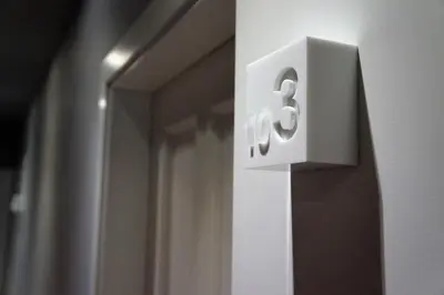 a white clock on a wall next to a mirror at Casa Amando in Somozas