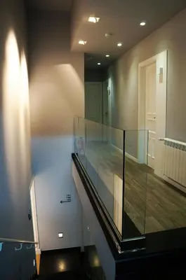 a staircase with a glass railing in a room at Casa Amando in Somozas