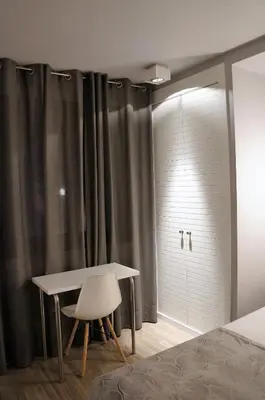a bedroom with a table and a sliding glass door at Casa Amando in Somozas