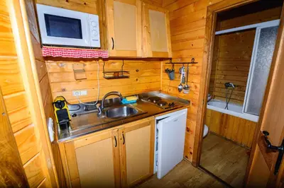 a small kitchen with a sink and a microwave at Casas Rurales San Justo in San Justo