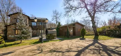 a large house with a tree and a driveway at Casas Rurales San Justo in San Justo