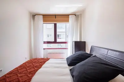 a bedroom with a large bed with a window at Apartamento Lua in Milladoiro