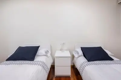 two beds sitting next to each other in a room at Apartamento Lua in Milladoiro