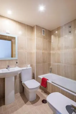 a bathroom with a toilet and a sink and a tub at Apartamento Lua in Milladoiro