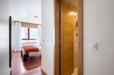a door to a bedroom with a bed in a room at Apartamento Lua in Milladoiro