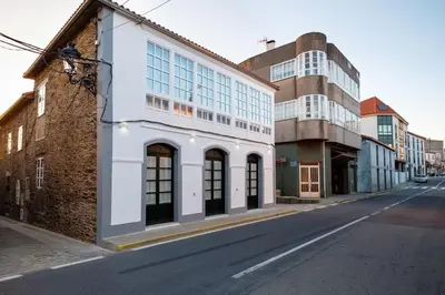 an empty street with buildings on either side at Pensión Domus Gallery in Arzúa