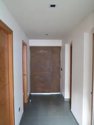 a hallway with a wooden door in a room at Alojamientos Marel Sanabria in Villarino de Sanabria