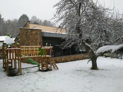 a playground in a yard covered in snow at Alojamientos Marel Sanabria in Villarino de Sanabria