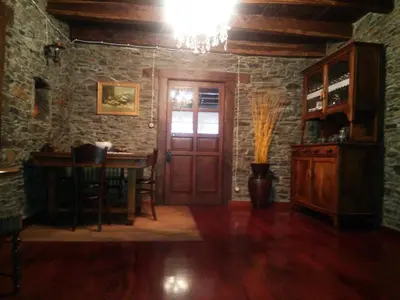 a room with a wooden door and a table with a desk at Casa Colason in El Otero