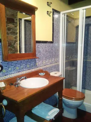 a bathroom with a sink and a toilet and a mirror at Casa Colason in El Otero