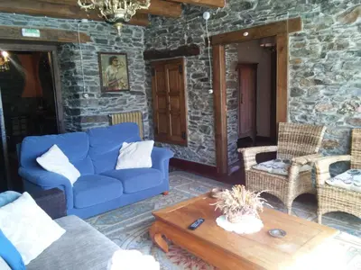 a living room with a blue couch and chairs at Casa Colason in El Otero