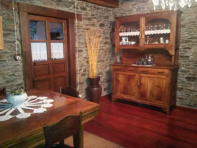 a dining room with a wooden table and a cabinet at Casa Colason in El Otero